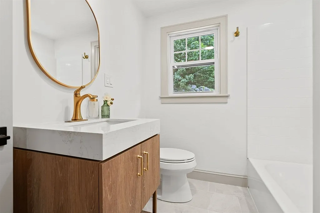 Bathroom, wood vanity and gold fixtures